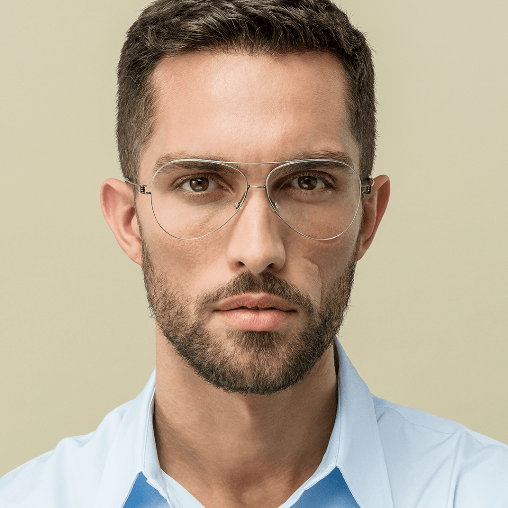 Man wearing Lindberg Air Titanium Rim aviator-style glasses with ultra-lightweight silver rimless titanium construction — fitted at Elevate Vision Care in Markham