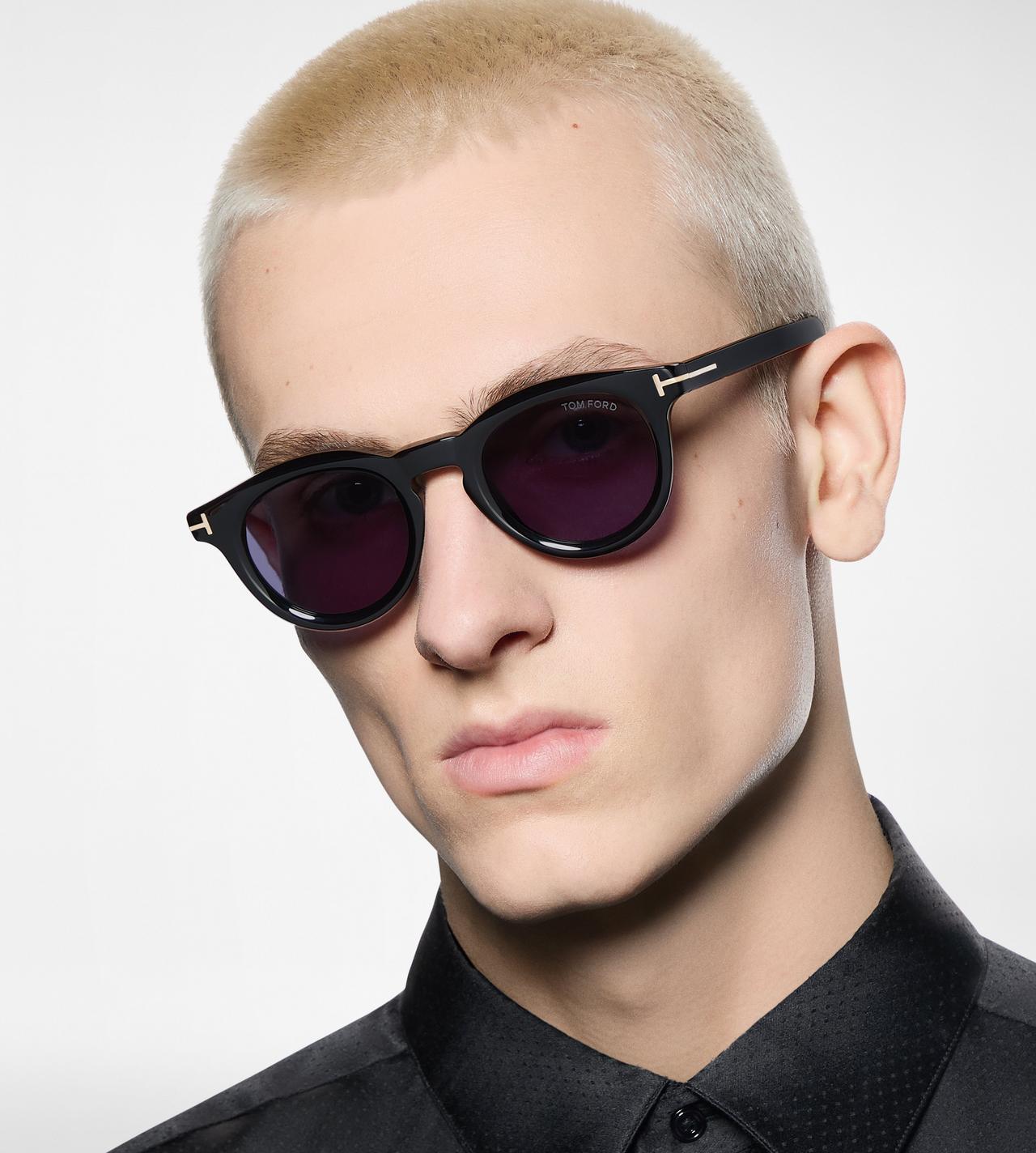 Man wearing Tom Ford round acetate sunglasses in black with signature T-logo temples β available at Elevate Vision Care in Markham