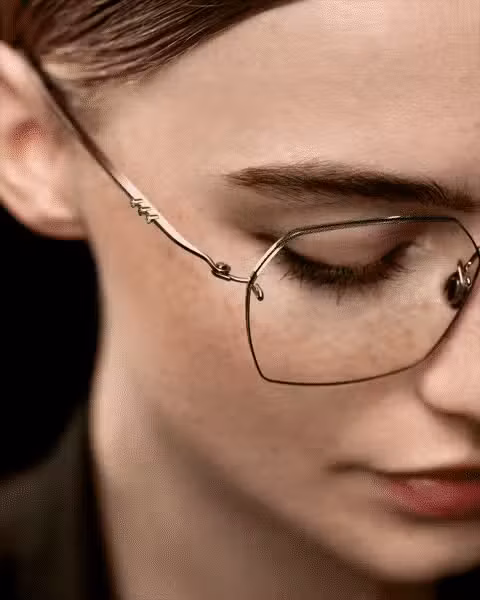 Woman wearing Lindberg Precious Berit rimless glasses in rose gold, handcrafted from precious metals with signature screwless hinge construction